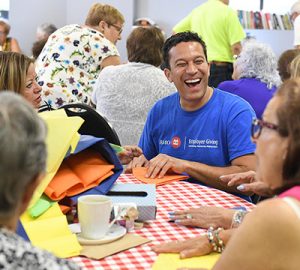A BMO employee does crafts with participants during an Employee Giving event