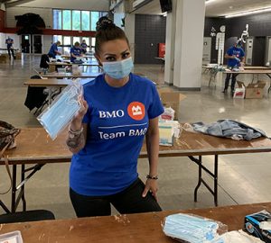 A volunteer assembling PPE kits