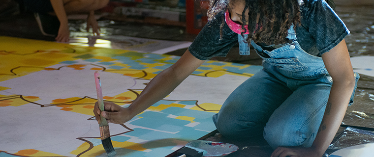 A student painting a mural