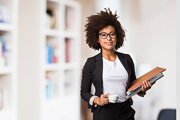 A woman of color holding files