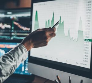 A hand pointing to a screen with data on it