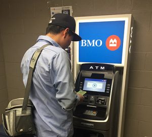 A farm employee using a BMO ATM
