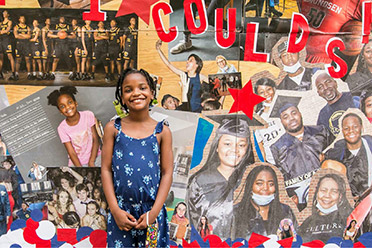 A little girl standing in front of a mural