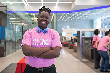 A woman wearing a pink International Day of Pink t-shirt