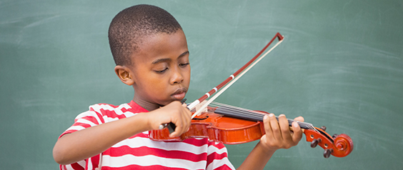 A little boy playing the violin