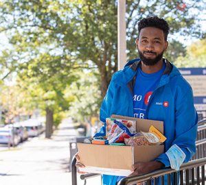 A BMO employee with a box of groceries