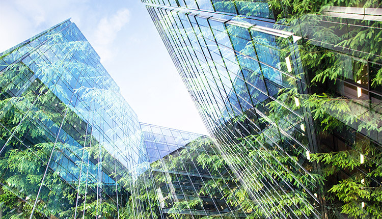 Low angle view of tall building with green spaces