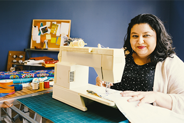 Indigenous women working at a sewing machine